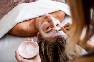 Woman getting a facial mask applied at Lemongrass Salon and Spa